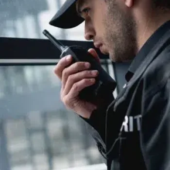 Security-guard-holding-a-walkie-talkie